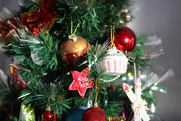Artificial Christmas tree glowing with festive decorations.