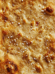 Freshly baked, crispy flatbread topped with sea salt perfect for any meal or snack in a cozy kitchen setting