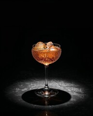 Negroni cocktail with ice cubes in elegant glass on dark background
