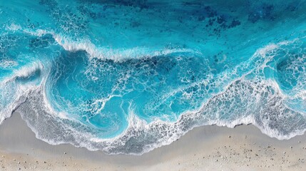 An overhead view reveals a vibrant turquoise ocean, with foamy white waves lapping at a light beige shore. The intricate texture and colors create a serene coastal scene.