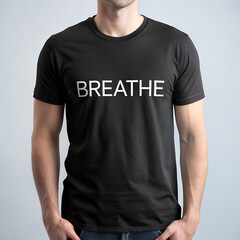 Man wearing a black tshirt with the word breathe printed in white, promoting mindfulness and calm
