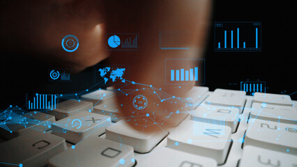 Close-up image of a finger typing on a keyboard, overlaid with digital data visualizations including graphs, charts, and a world map, depicting a modern workspace. Xenic