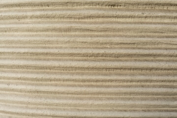 Striped surface with natural horizontal rhythm and textured relief lines. This photo describes the concept of structure, repetition, abstraction, minimalism, and geometric design.