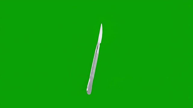 Sharp surgical scalpel isolated on a vibrant green background, ready for precise procedures.