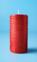 New year and christmas decoration with blurred candle over blue background.
