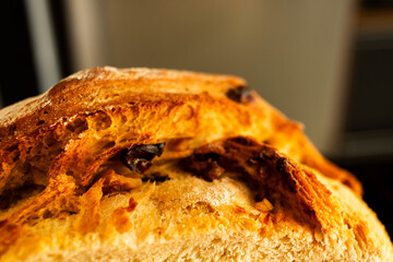 Close-up of a rustic homemade bread loaf with a blurred background.