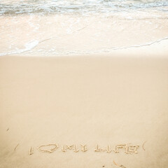 The photo shows a fragment of the beach in Sopot, Poland, where someone wrote “I ❤️ MY LIFE” in the sand.