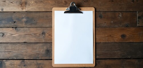 Empty clipboard on rustic wooden surface, top view. Blank white paper offers ample space for text or design elements. Minimalist template for creative workspace, office notes, or planning.