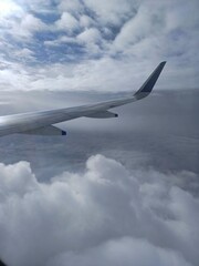view from airplane window, view from the plane, airplane in the clouds.