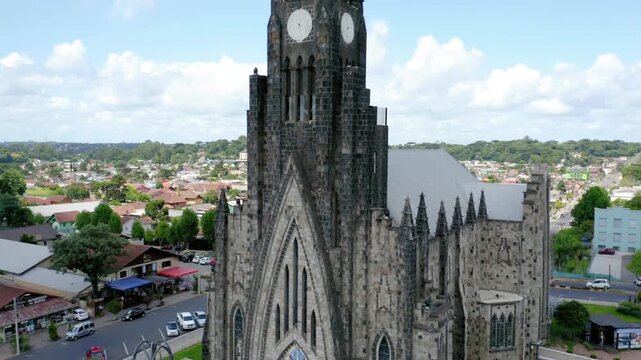 Stone cathedral stands tall against a partly cloudy sky in canela, brazil