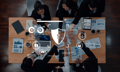 A diverse business team engages in a dynamic meeting, analyzing data and discussing innovative security strategies with digital elements illustrating growth and technology. Trope