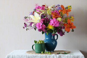Colorful summer flowers bouquet and green gooseberry still life
