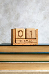 September 1 calendar block sitting on school books