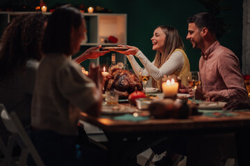 Friends sharing food at thanksgiving dinner table