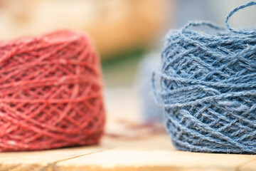 There are balls of thread of different colors on the table.
