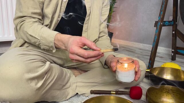 Man lighting incense for meditation and spiritual practice