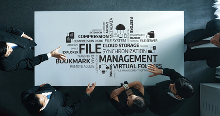 A modern office scene depicting professionals actively discussing file management solutions, cloud...