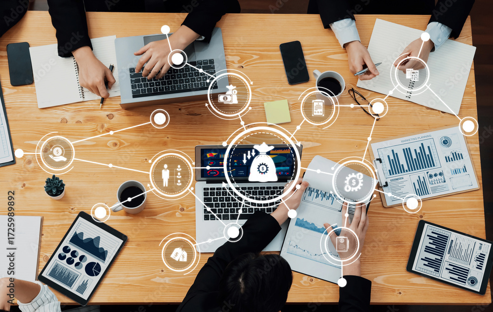 Poster a dynamic business meeting showing teamwork and collaboration with laptops, visual data analysis, an