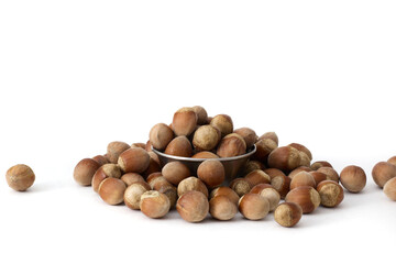 A small metal bowl filled with whole hazelnuts, placed against a clean white background, highlighting their natural texture and perfect for food photography or healthy eating concepts.