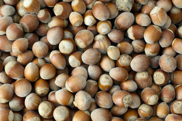 Whole hazelnuts showcasing their natural texture and rich brown color, perfect for food and health concepts.