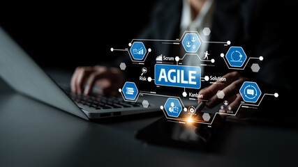 A business professional engages with a laptop and tablet, showcasing Agile project management tools...