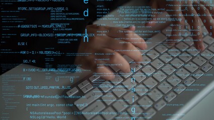 Close-up view of hands typing on a modern keyboard surrounded by streams of digital code,...