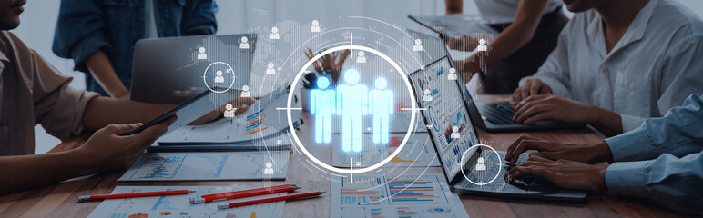 A team collaborates in a modern digital workspace, utilizing technology and visual data to enhance...