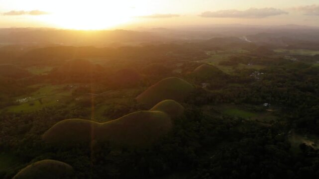 The chocolate hills of bohol, philippines are illuminated by the rising sun