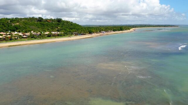 Aerial view of a tropical beach with turquoise water and green vegetation