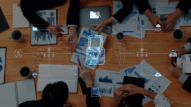 A bustling business meeting centered on data security features professionals analyzing charts on various devices, highlighting collaboration and strategic planning. Raster