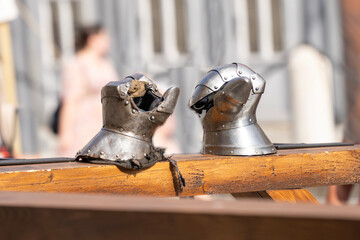 Medieval knight's steel gloves on a wooden railing