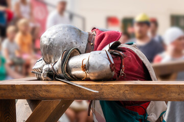 Medieval knight resting in armor at a jousting tournament