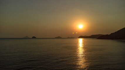 Aerial 4K drone footage of tropical beach coastline with turquoise sea, golden sand and blue sky