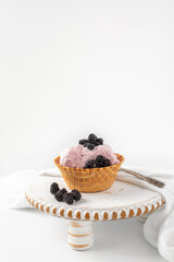 Blackberry Ice Cream in a Waffle Bowl on White Background with Room for Text