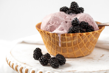 Close Up of Blackberry Ice Cream in a Waffle Bowl on a White Background, a Drip Going Down the Side of the Cone,, Room for Text