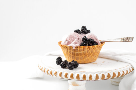Blackberry Ice Cream in a Waffle Bowl on White Background with Room for Text