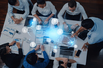Professionals collaborate at a conference table, engaging with digital currencies and financial data, illustrating teamwork and innovation in modern business finance. Trope