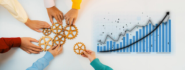 Obraz premium Diverse hands assembling gears symbolize teamwork, while a chart displays upward growth, emphasizing collaboration in achieving business success and innovative strategy. Axiom
