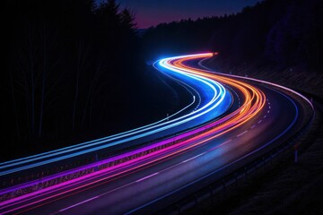 Long exposure shot of colorful light trails on a winding road at night