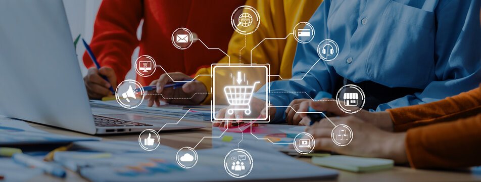 A dynamic team collaborates on an e-commerce project in a modern workspace, utilizing digital tools and online icons to shape their marketing strategy. Trope - Powered by Adobe