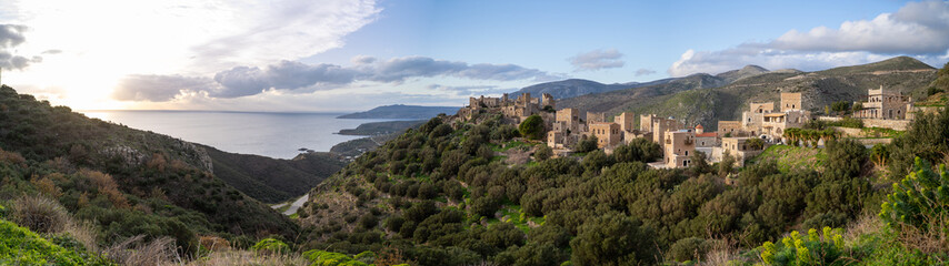 high pressure water jet to cleaning ship with Rio-Antirio Charilaos Trikoupis bridge in background at daylight, Greece.