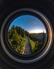 Fisheye view of a mountain path at sunset through a camera lens