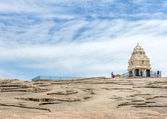 Bangalore, Karnataka, India - October 5, 2013: Lal Bagh Botanical Garden. Exposed gneiss hillock ancient rock formation with one of the 4 Cardinal towers of the city, a Hindu religious site