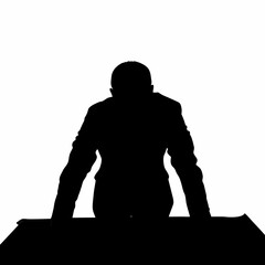 A senior businessman in silhouette leaning over a desk, analyzing strategy or data.