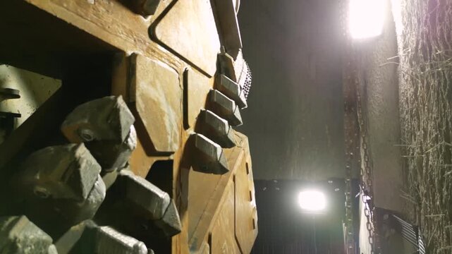 Close up of tunnel boring machine cutter head teeth drilling underground rock surface with industrial detail of sharp metal blades and mechanical structure in heavy engineering construction project
