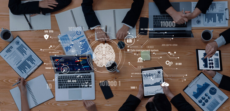 A business team engages in a collaborative data analysis project, utilizing modern technology and digital tools to enhance decision-making and insights. Trope - Powered by Adobe