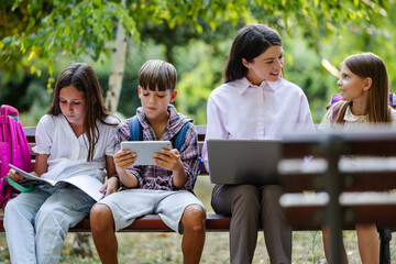 Teacher enjoying leisure time with kids in nature
