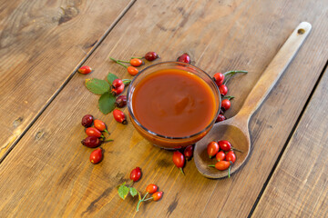 still life with red berries
Rosehip berries and rosehip marmalade in a glass bowl on a wooden table