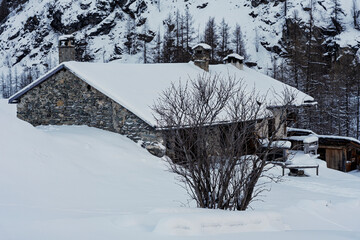 France - Peisey-Nancroix - Les Lanches - Rustic stone house covered in snow
