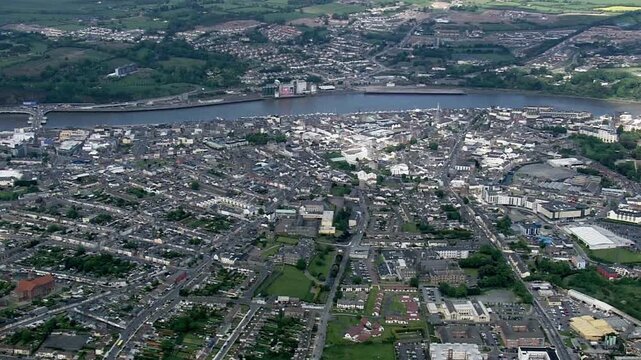 Aerial view captures the cityscape of derry, northern ireland, along the river foyle